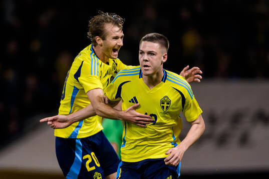 Benjamin Nygren and Emil Holm of Sweden celebrate the 1-0