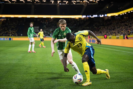 Terry Devlin of Northern Ireland and Ken Sema of Sweden