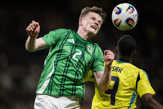Terry Devlin of Northern Ireland and Alexander Isak of