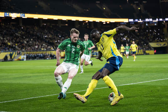 Terry Devlin of Northern Ireland and Ken Sema of Sweden