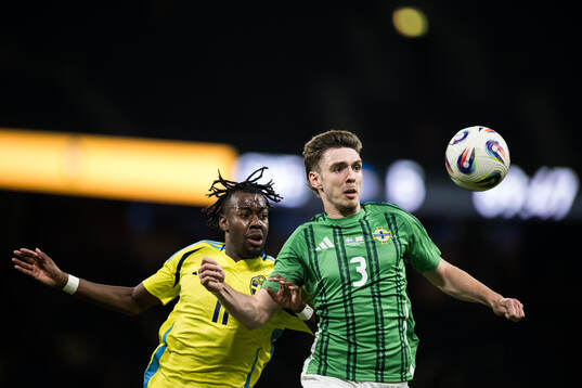 Anthony Elanga of Sweden and Ruairi McConville of Northern