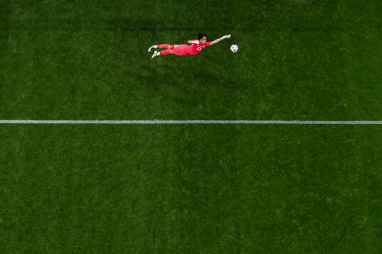 Goalkeeper Pierce Charles of Northern Ireland lets in the