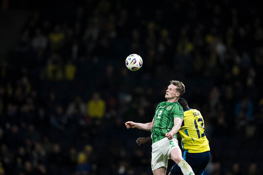 Terry Devlin of Northern Ireland and Ken Sema of Sweden