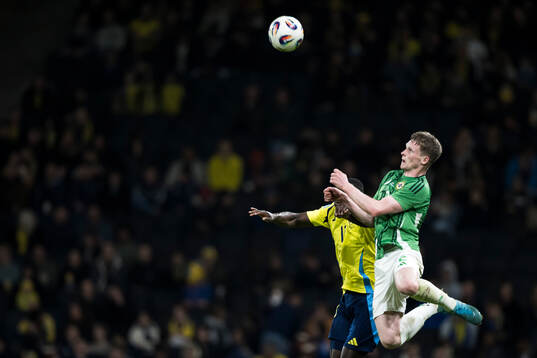 Terry Devlin of Northern Ireland and Ken Sema of Sweden