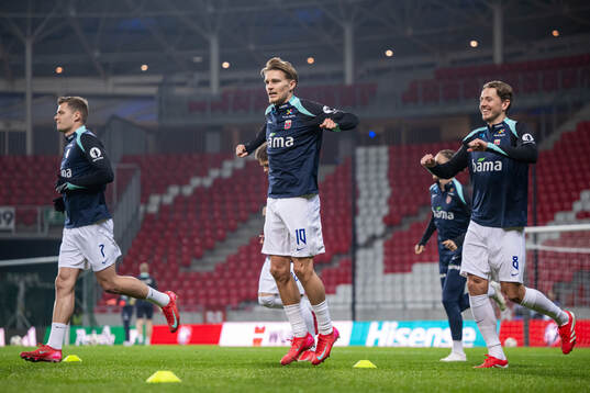 Martin Ødegaard and Sander Berge of Norway warm up