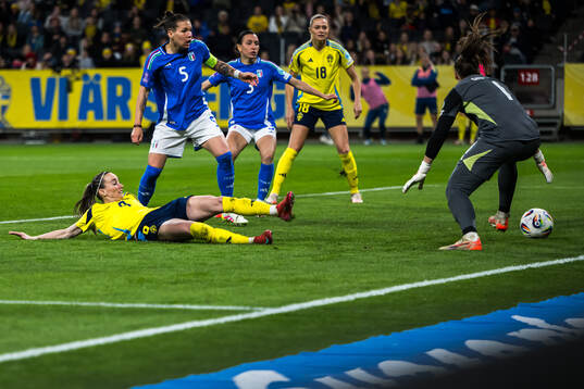 Kosovare Asllani of Sweden scores 1-1 in competition with