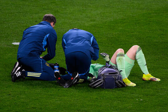 Goalkeeper Jennifer Falk of Sweden receives medical