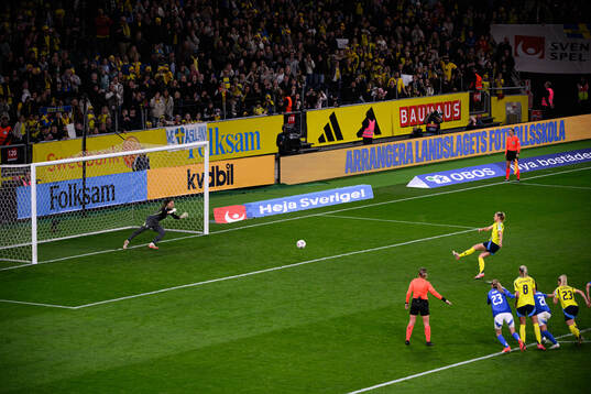 Fridolina Rolfö of Sweden scores 3-2 behind goalkeeper