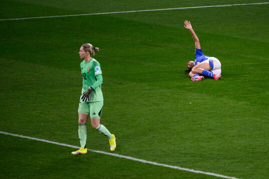 Chiara Beccari of Italy in pain behind goalkeeper Jennifer