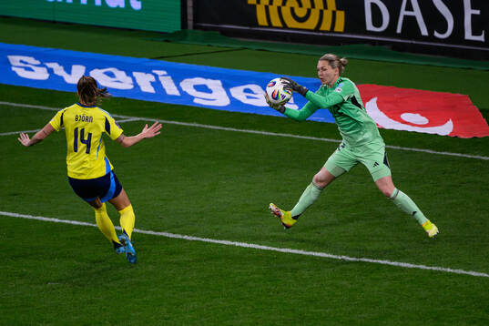 Nathalie Björn and goalkeeper Jennifer Falk of Sweden