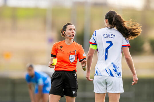 Referee Silvia Gasperotti gives a yellow card to Ingrid