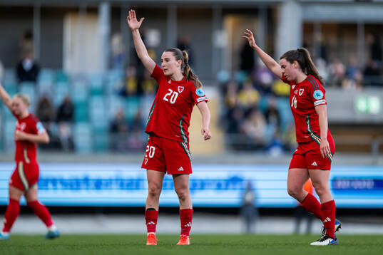Carrie Jones and Mared Griffiths of Wales react