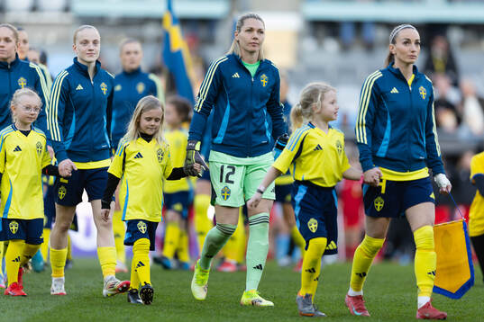 Goalkeeper Jennifer Falk and Kosovare Asllani of Sweden