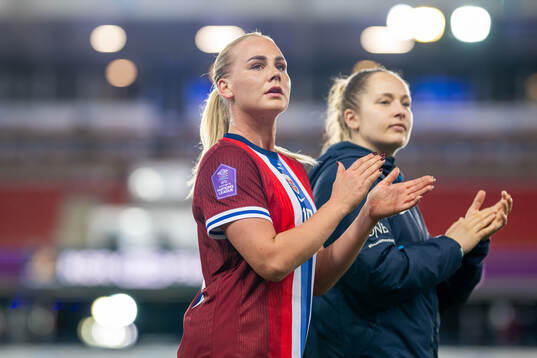 Cathinka Tandberg and goalkeeper Aurora Mikalsen of Norway