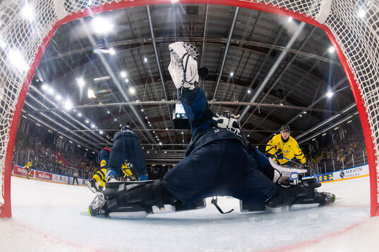 Felix Nilsson of Sweden scores 1-1 behind goaltender Oskari