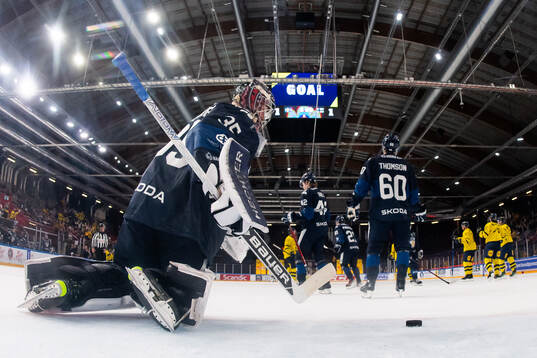 Goaltender Oskari Salminen of Finland looks dejected