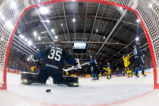 Goaltender Oskari Salminen of Finland looks dejected