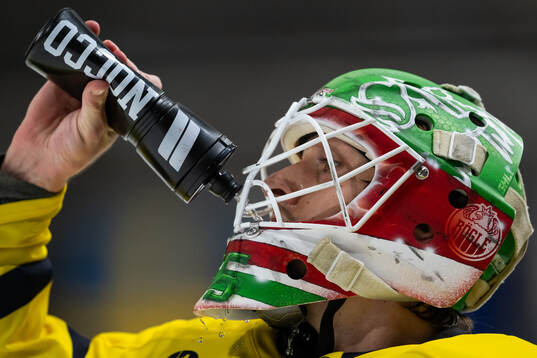 Goaltender  Arvid Holm of Sweden drinks water
