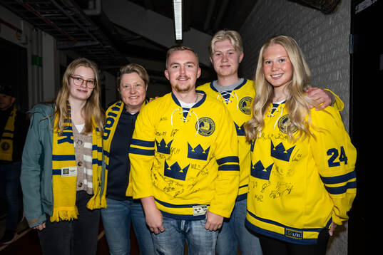 Spectators pose for a photo