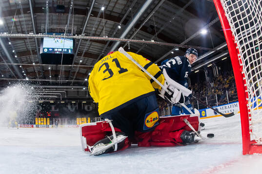 Lenni Härmeenaho of Finland and goaltender Tim Juel of