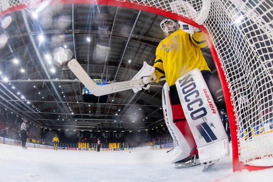 Goaltender Tim Juel of Sweden looks dejected