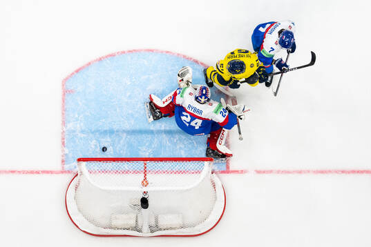 Emil Heineman of Sweden with goaltender Patrik Rybar and