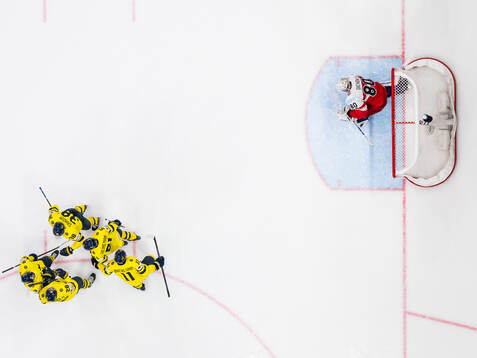 Mikael Backlund of Sweden celebrates with Elias Lindholm,