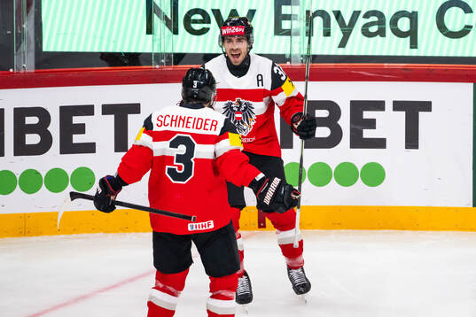 Bernd Wolf of Austria celebrates with Peter Schneider