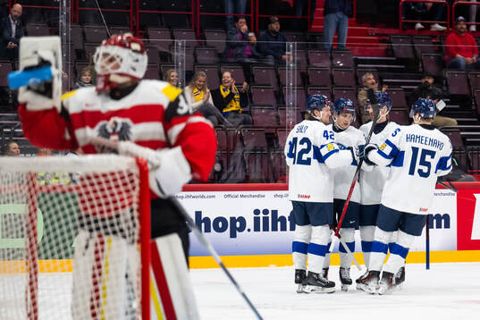 Patrik Puistola of Finland celebrates with team mates