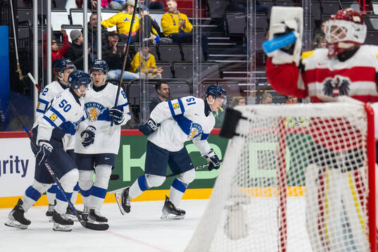 Juuso Pärssinen of Finland celebrates with team mates