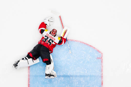 Goaltender Atte Tolvanen of Austria looks dejected