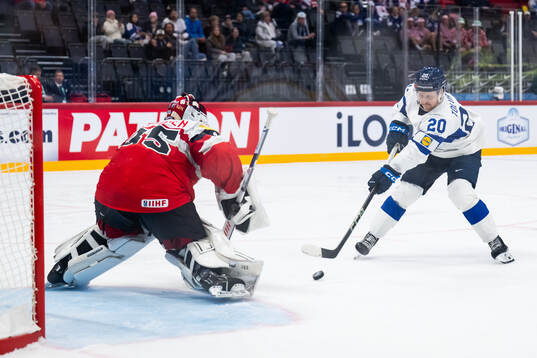 Goaltender Atte Tolvanen of Austria and Eeli Tolvanen of