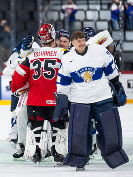 Goaltender Atte Tolvanen of Austria with Eeli Tolvanen of