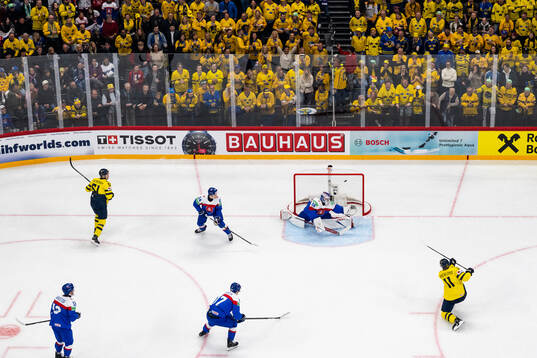 Mikael Backlund of Sweden scores 1-0 behind goaltender