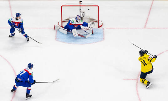 Mikael Backlund of Sweden scores 1-0 behind goaltender