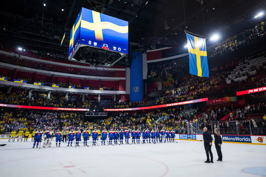 Players of Sweden and of Slovakia as the Swedish flag is