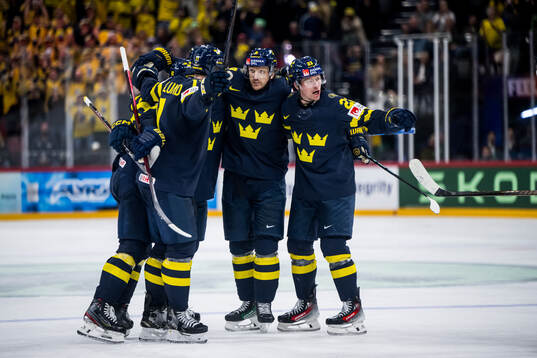 Jonas Brodin and Lucas Raymond of Sweden celebrating