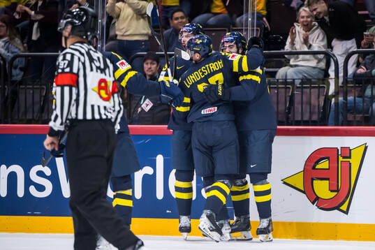 Mika Zibanejad and Isac Lundeström of Sweden celebrating