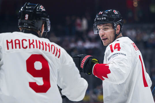 Nathan MacKinnon and Bo Horvat of Canada celebrate