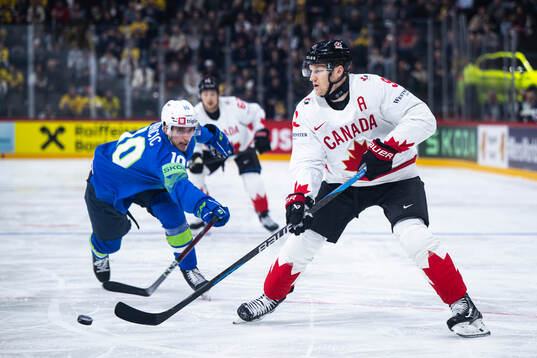 Miha Bericic of Slovenia and Nathan MacKinnon of Canada