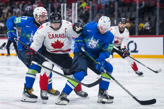 Rok Macuh and Jan Cosic of Slovenia and Sidney Crosby of