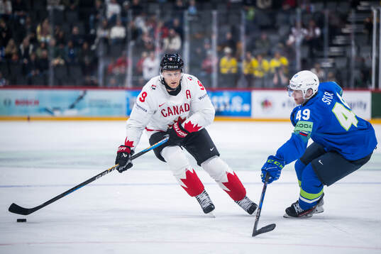 Nathan MacKinnon of Canada and Filip Sitar of Slovenia