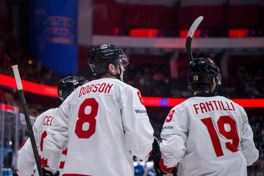 Noah Dobson of Canada celebrate with teammates