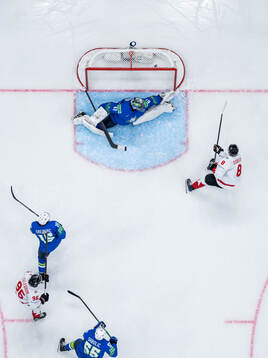 Noah Dobson of Canada scores the 0-4 goal behind goalkeeper