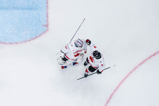 Goaltender Dylan Garand and Noah Dobson celebrate