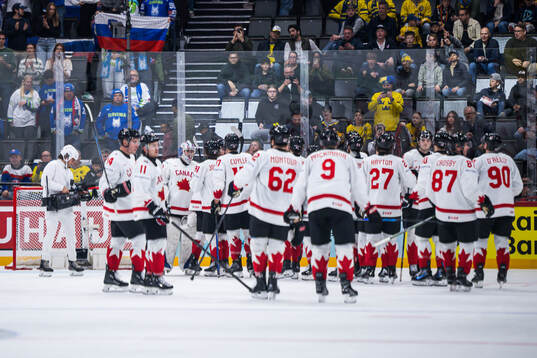 Goaltender Dylan Garand of Canada celebrate with teammates