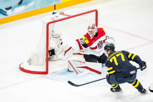 Goaltender David Kickert of Austria and Simon Edvinsson of