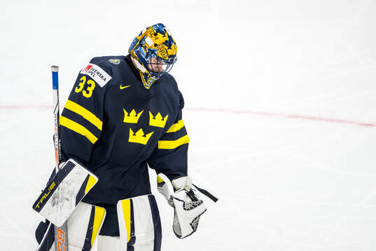 Goaltender Samuel Ersson of Sweden looks dejected