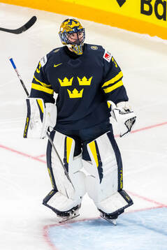 Goaltender Samuel Ersson of Sweden looks dejected