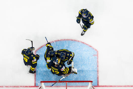 Goaltender Samuel Ersson of Sweden celebrate with Rasmus